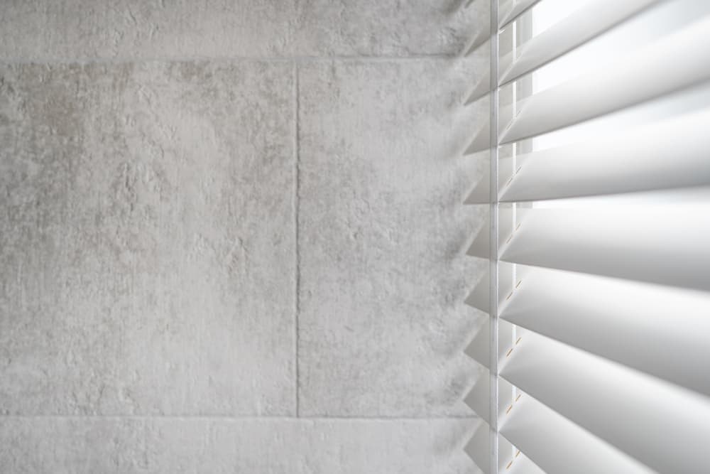 close up image of white shutters against a window