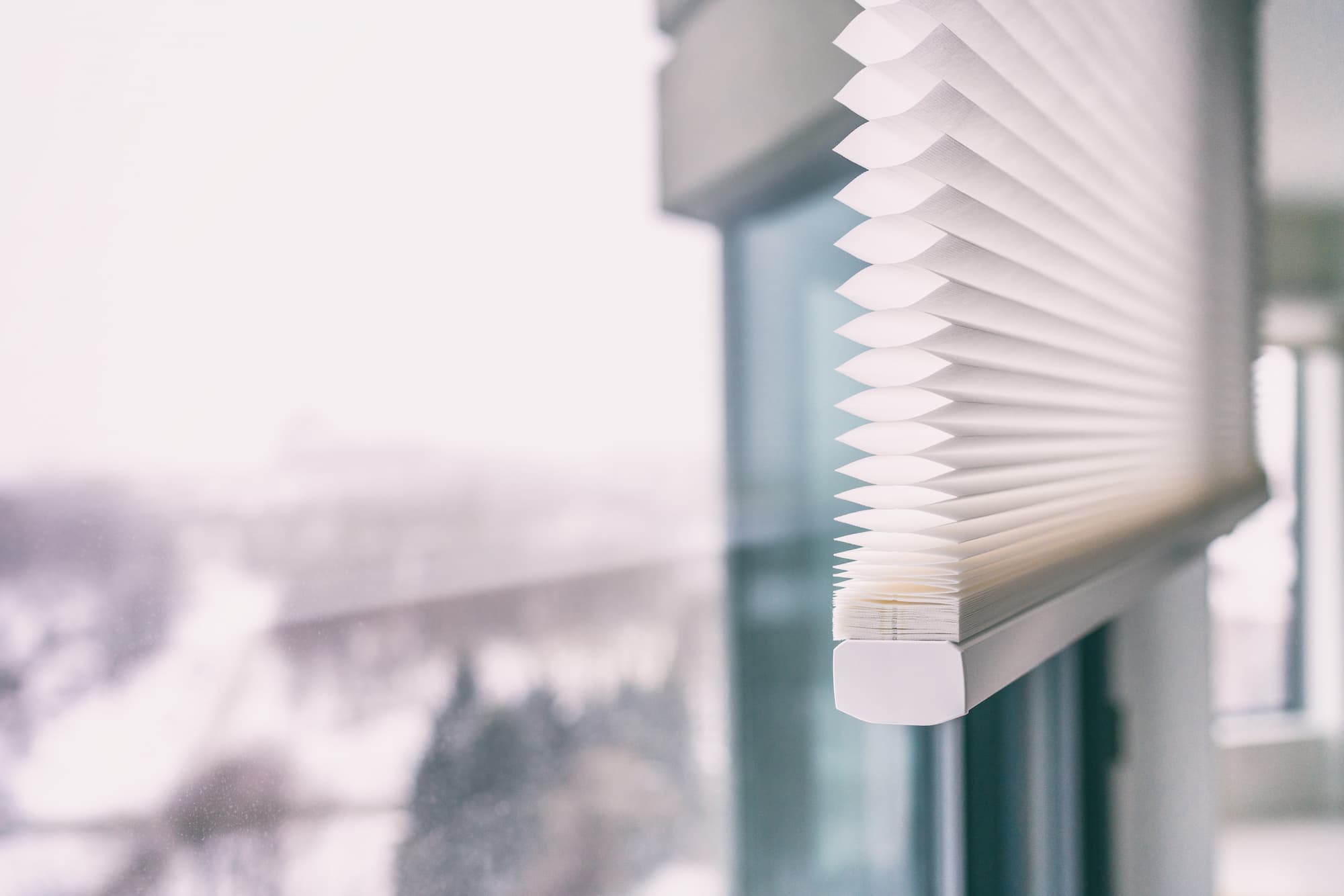 a close up image of an installed cellular shade against a window