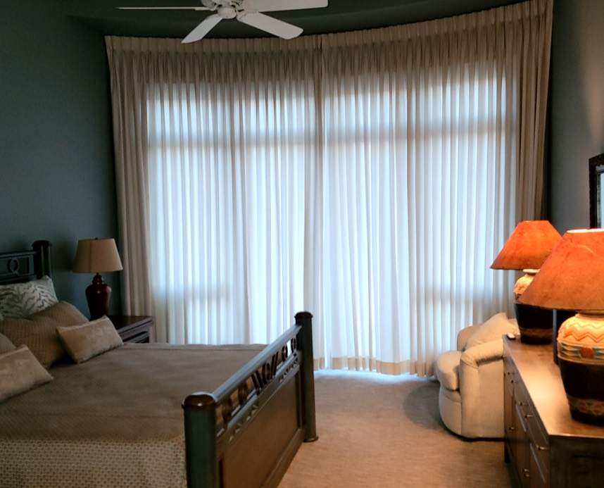 Custom Window Shades-a dim cozy bedroom with custom shades