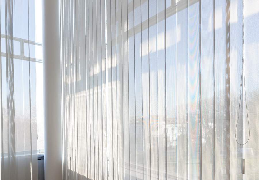 vertical shades detail with warm sunlight streaming through